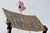 A man holds a sign reading ″SNAP Feeds Families,″ as food aid benefits come under threat due to the ongoing U.S. government shutdown, during ″A Rally for SNAP″ on the steps of the Massachusetts Statehouse in Boston, Massachusetts, on Oct. 28. [REUTERS/YONHAP]