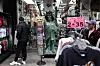 People browse outside a gift shop in the Chinatown neighborhood of Manhattan, New York, on April 13. China said on April 11 that it would raise its tariffs on U.S. goods to 125 percent in a further escalation of a trade war that threatens to bring exports to a halt between the world's two biggest economies. Beijing's retaliation sparked fresh market volatility, with stocks seesawing, gold prices surging and U.S. government bonds under pressure. [AP/YONHAP]