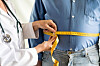 A doctor measures a patient's waist circumference in this file photo. [GETTY IMAGES BANK]