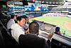 Seoul Mayor Oh Se-hoon, left, learns about the Rogers Centre in Toronto from Anuk Karunaratne, the executive vice president for business operations for the Toronto Blue Jays, at a private box on Saturday. [SEOUL METROPOLITAN GOVERNMENT]