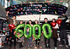 Traders celebrate the Kospi closing above the 6,000-point mark for the first time at the trading room of Hana Bank in central Seoul on Feb. 25. [YONHAP]