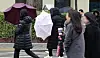 Residents pass a sidewalk in Seoul as the capital experienced volatile weather on Feb. 5, accompanied by strong winds and sleet. [YONHAP]