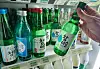A customer picks out a bottle of Chamisul at a convenience store in Seoul on Jan. 2, 2024. [NEWS1]