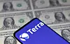 Smartphone with Terra logo is placed on displayed U.S. dollars in this illustration taken on May 11, 2022. [REUTERS/YONHAP]
