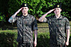 Members Jungkook, left, and Jimin of boy band BTS salute fans after finishing their military duties on June 11 in Yeoncheon, Gyeonggi. [NEWS1]