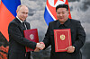 North Korean leader Kim Jong-un, right, and Russian President Vladimir Putin sign joint documents during a ceremony at the Kumsusan State Guest House in Pyongyang on June 19. [TASS/YONHAP]