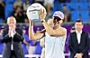 Iga Swiatek of Poland holds the trophy after winning the women's singles title at the Korea Open at Olympic Park Tennis Center in Seoul on Sept. 21. [YONHAP]