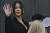 Kim Kardashian waves as she arrives to testify regarding a robbery of millions of dollars in jewels from her Paris hotel room in 2016, in Paris, May 13, 2025. [AP/YONHAP]