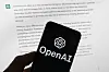 The OpenAI logo is seen on a mobile phone in front of a computer screen displaying output from ChatGPT on March 21, 2023 in Boston. [AP/YONHAP]