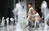 Children play in the water at Gwanghwamun Square in Jongno District, central Seoul as temperatures reached early summer weather on April 17. [YONHAP]