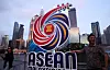 People pose with the Association of Southeast Asian Nations (Asean) logo against the backdrop of Kuala Lumpur's skyline, ahead of the Asean Foreign Ministers' Meeting in Kuala Lumpur, Malaysia, on July 8. [REUTERS/YONHAP]