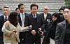 Democratic Party leader Lee Jae-myung, center, arrives at the Seoul Central District Court in Seocho District, southern Seoul, to attend a hearing of his trial on charges of breach of trust and bribery on April 8. [NEWS1]