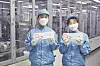 SK On engineers pose with pouch-type batteries [SK ON]