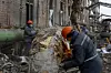 Workers remove insulation from a pipe at a compound of Darnytsia Thermal Power Plant, which was heavily damaged by recent Russian missile and drone strikes, amid Russia's attack on Ukraine, in Kyiv, Ukraine, on Feb. 4. [REUTERS/YONHAP]