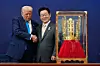 U.S. President Donald Trump shakes hands with Korean President Lee Jae Myung as he receives a gift of a gold crown and an award of the Grand Order of Mugunghwa, not seen, during a high honor ceremony at the Gyeongju National Museum in Gyeongju, North Gyeongsang, on Oct. 29, 2025. [AP/YONHAP]