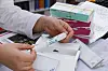 A pharmacist hands out a Wegovy pen at a pharmacy in Jongno District, central Seoul. [YONHAP]