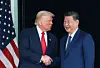 U.S. President Donald Trump and Chinese President Xi Jinping talk as they leave after a bilateral meeting at Gimhae International Airport, on the sidelines of the Asia-Pacific Economic Cooperation summit, in Busan on Oct. 30. [REUTERS/YONHAP]