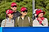 Spectators wearing red caps saying “H. J. Kim,” watch the Aramco Team Series presented by Public Investment Fund at the New Korea Country Club in Goyang, Gyeonggi on Friday. [ARAMCO TEAM SERIES]