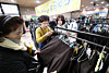 Parents browse and buy donated middle and high school uniforms from Gwacheon at a school uniform event held on Feb. 5 in the lobby outside the Green Shop at Gwacheon Citizens Hall in Gwacheon, Gyeonggi. [NEWS1]