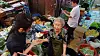 First lady Kim Keon Hee, left, is seen talking to a vendor at a traditional market in Bupyeong District, Busan, while shopping for groceries on Tuesday. [SCREEN CAPTURE]
