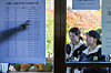 Students taking the 2026 College Scholastic Ability Test check their testing room assignments at a high school in Jung District, central Seoul, on Nov. 12. [NEWS1]