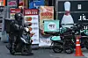 A delivery worker parks his motorcycle in front of a cluster of restaurants in Seoul in February. [YONHAP]