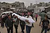 Mourners carry the body of a Palestinian for burial after the person was killed in an Israeli military airstrike that hit a U.N. school, in Jabaliya, northern Gaza Strip on May 12, 2025. [AP/YONHAP]