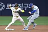Los Angeles Dodgers' wesFtinto a fielder's choice as San Diego Padres shortstop Kim Ha-seong tries to throw out Smith at first during the fifth inning of an opening day game at Gocheok Sky Dome in western Seoul on Wednesday. [AP/YONHAP]