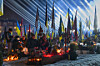 Floodlights shine over the graves of the fallen soldiers as people gather around candles lit on the eve of the fourth anniversary of Russia’s full-scale invasion in Lviv, Ukraine, on Feb. 23. [AP/YONHAP]