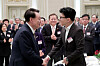 President Yoon Suk Yeol, left, shakes hands with Han Dong-hoon, interim leader of the conservative People Power Party and former justice minister, at the Blue House in Seoul on Wednesday. [JOINT PRESS CORPS]