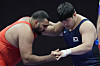 Korean wrestler Kim Min-seok, right, competes during the men's Greco-Roman 130-kilogram bronze medal bout at the Hangzhou Asian Games against Naveen of India at Lin’an Sports Culture & Exhibition Centre in Hangzhou, China on Thursday. [AP/YONHAP]