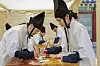 Visitors make daenggi (traditional Korean hair ribbon) in the 2025 Spring K-Royal Culture Festival at the Gyeongbok Palace in Jongno District, central Seoul, on April 26, 2025. [KOREA HERITAGE AGENCY]