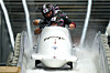 Kim Jin-su, Kim Hyeong-geun, Lee Geon-u and Kim Sun-wook arrive at the finish during a four man bobsled run at the 2026 Winter Olympics in Cortina d'Ampezzo, Italy, on Feb. 22. [AP/YONHAP]