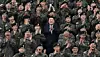 President Yoon Suk Yeol, center, poses for a picture with soldiers on Tuesday, at the 15th Infantry Division in Gangwon. Second row, third from right, RM of BTS is seen clapping. [PRESIDENTIAL OFFICE]