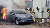 Firefighters douse flames erupting from a Hyundai Kona electric vehicle that burst into flames last July near an office in Gangneung, Gangwon. [GANGNEUNG FIRE DEPARTMENT]