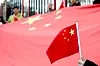 A person holds a Chinese flag outside a hotel where Chinese President Xi Jinping was staying in Moscow on May 7. [TASS/YONHAP]