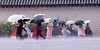 People walk in the rain near the National Palace Museum of Korea in Jongno District, central Seoul, as heavy rains fell in the metropolitan area on Aug. 13. [NEWS1]