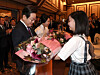 President Lee Jae Myung, left, and first lady Kim Hea Kyung receive flowers from children during a luncheon meeting with the Korean community in Japan at a hotel in Tokyo on Aug. 23. [JOINT PRESS CORPS]