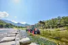 A tractor crosses a river on its way to Menge Village in Andong, North Gyeongsang. [KORAIL TOURISM DEVELOPMENT]