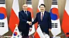 President Yoon Suk Yeol, right, and Polish President Andrzej Duda shake hands at their bilateral summit at the Yongsan presidential office in central Seoul on Thursday. [JOINT PRESS CORPS]