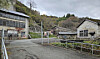 Old buildings are seen near the entrance road leading into the Sado mine tunnels on Sado Island in Niigata Prefecture, Japan, where the Korean government held a memorial ceremony on Nov. 21 for victims of forced labor mobilized during Japan’s colonial rule. [YONHAP]