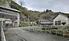 Old buildings are seen near the entrance road leading into the Sado mine tunnels on Sado Island in Niigata Prefecture, Japan, where the Korean government held a memorial ceremony on Nov. 21 for victims of forced labor mobilized during Japan’s colonial rule. [YONHAP]