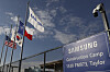 Samsung, Texan, Korean and U.S. flags hang in front of the Samsung semiconductor chip plant in Taylor, Texas, on Jan. 2, 2024. [EPA/YONHAP]