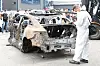 A Mercedes-Benz executive examines the burnt Mercedes EQE sedan in Incheon on Aug. 8. The Mercedes EQE EV explosion damaged as many as 880 vehicles parked in the garage. [NEWS1]