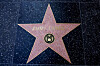 Jimmy Kimmel's star in the Hollywood Walk of Fame remains while people protest outside the Dolby Theatre, across the street from the theater where ″Jimmy Kimmel Live!″ was recorded for broadcast, following his suspension for remarks he made regarding Charlie Kirk’s assassination, on Hollywood Boulevard in Los Angeles, California, U.S. Sept. 22. [REUTERS/YONHAP]