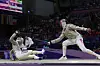 Gu Bon-gil, left, falls during the men's sabre individual round of 32 match against Turkey's Fares Ferjani at the Grand Palais in Paris on Saturday. [YONHAP]