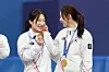 Korean short track skaters Kim Gil-li, left, and Choi Min-jeong are seen during the medal ceremony after the team won the 3,000-meter relay final at the 2026 Milan-Cortina Winter Olympics at the Milan Ice Skating Arena in Milan, Italy on Feb. 18. [KIM JONG-HO]
