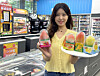 A model holds up Hong Qi's frozen sorbet treats at a GS25 convenience store in this photo provided by GS Retail on Aug. 29. [GS RETAIL]
