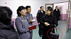 Ri Sol-ju, wife of North Korean leader Kim Jong-un, right, tours newly built facilities in Gangdong County, on the outskirts of Pyongyang on Dec. 15. The red circle shows a Gucci bag that Ri is clutching. [KOREAN CENTRAL NEWS AGENCY]
