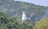 A helicopter deployed to fight the wildfire that broke out on Mount Hamji in Daeju is seen spraying water from above on April 29. [NEWS1]